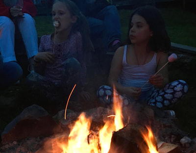 eating marshmallows by open fire